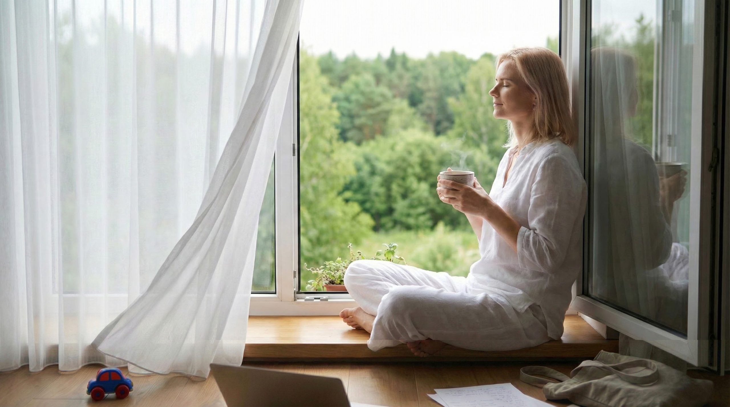 Aiva sitting by the window
